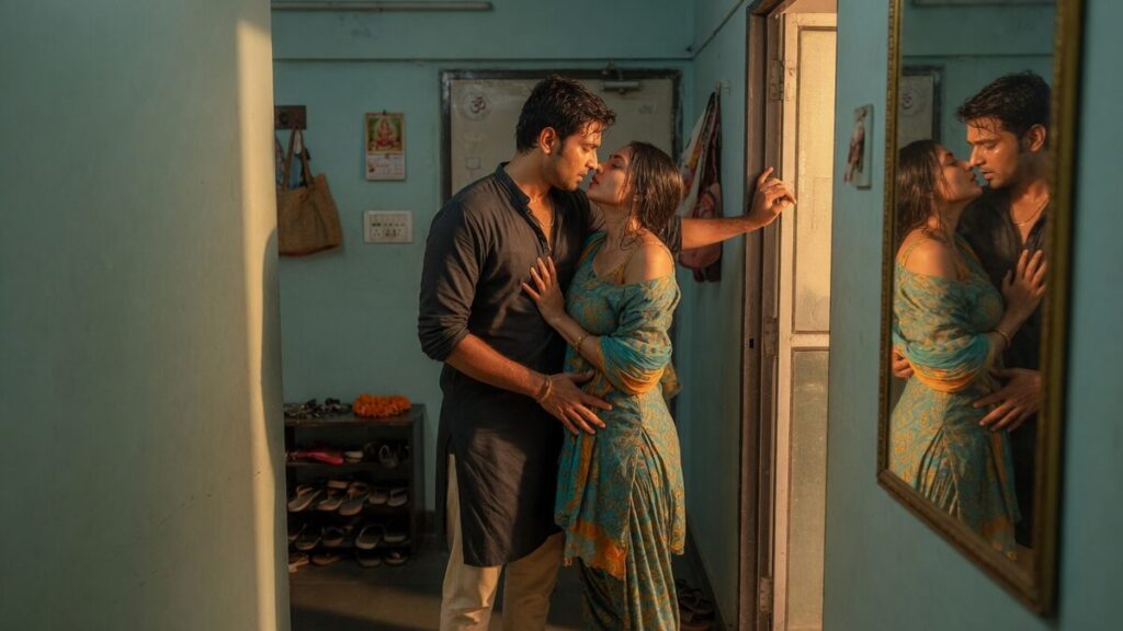 Two fully clothed adults, one adult Indian man and one adult Indian woman in a contemporary Indian city apartment entry.