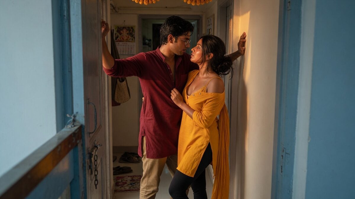 Two fully clothed adults, one adult Indian man and one adult Indian woman in an Indian apartment entry.
