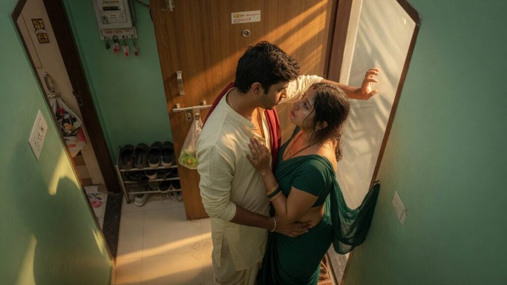 Two fully clothed adults, one adult Indian man and one adult Indian woman in a contemporary Indian city apartment entry.