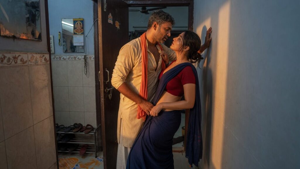 Two fully clothed adults, one adult Indian man and one adult Indian woman in an Indian apartment entry.
