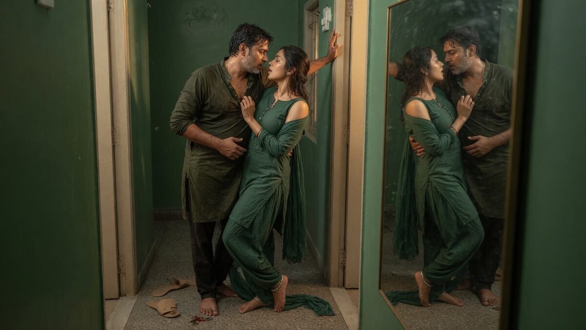 Two fully clothed adults, one adult Indian man and one adult Indian woman in an Indian apartment entry.