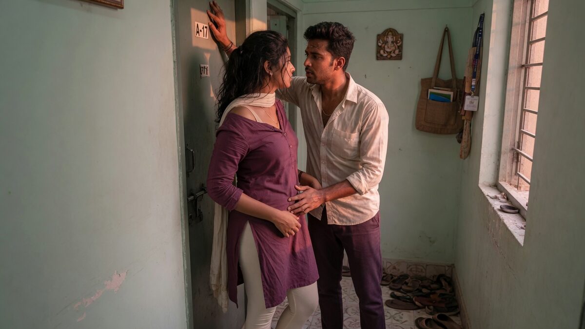 Two fully clothed adults, one adult Indian man and one adult Indian woman in an Indian apartment entry.
