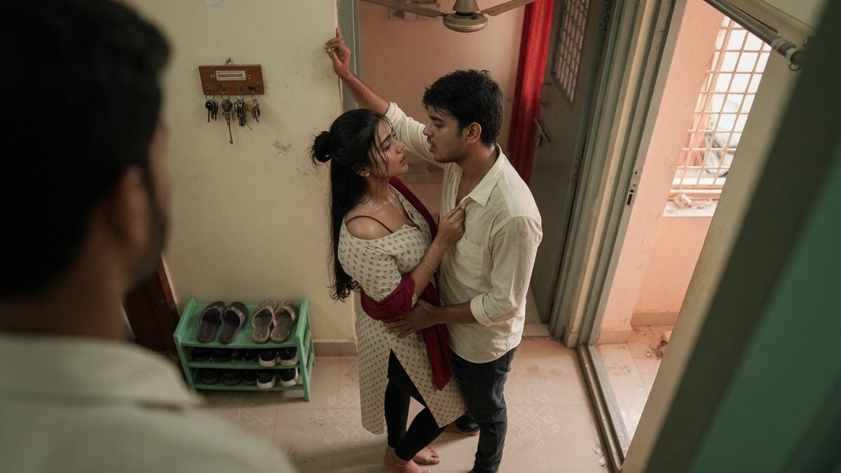 Two fully clothed adults, one adult Indian man and one adult Indian woman in an Indian apartment entry.