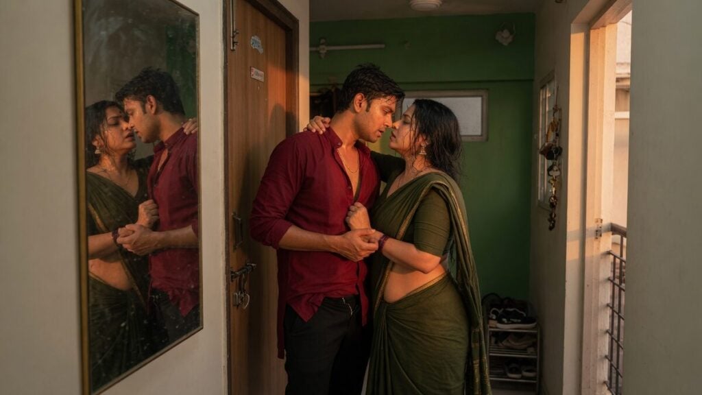 Two fully clothed adults, one adult Indian man and one adult Indian woman in a contemporary Indian city apartment entry.