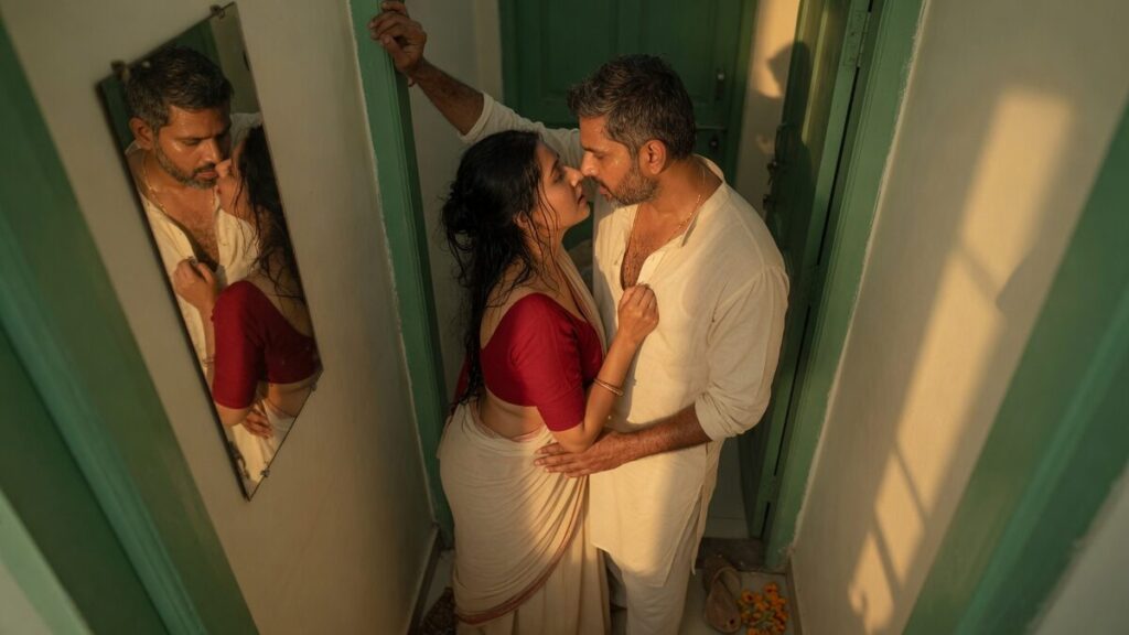 Two fully clothed adults, one adult Indian man and one adult Indian woman in an Indian apartment entry.